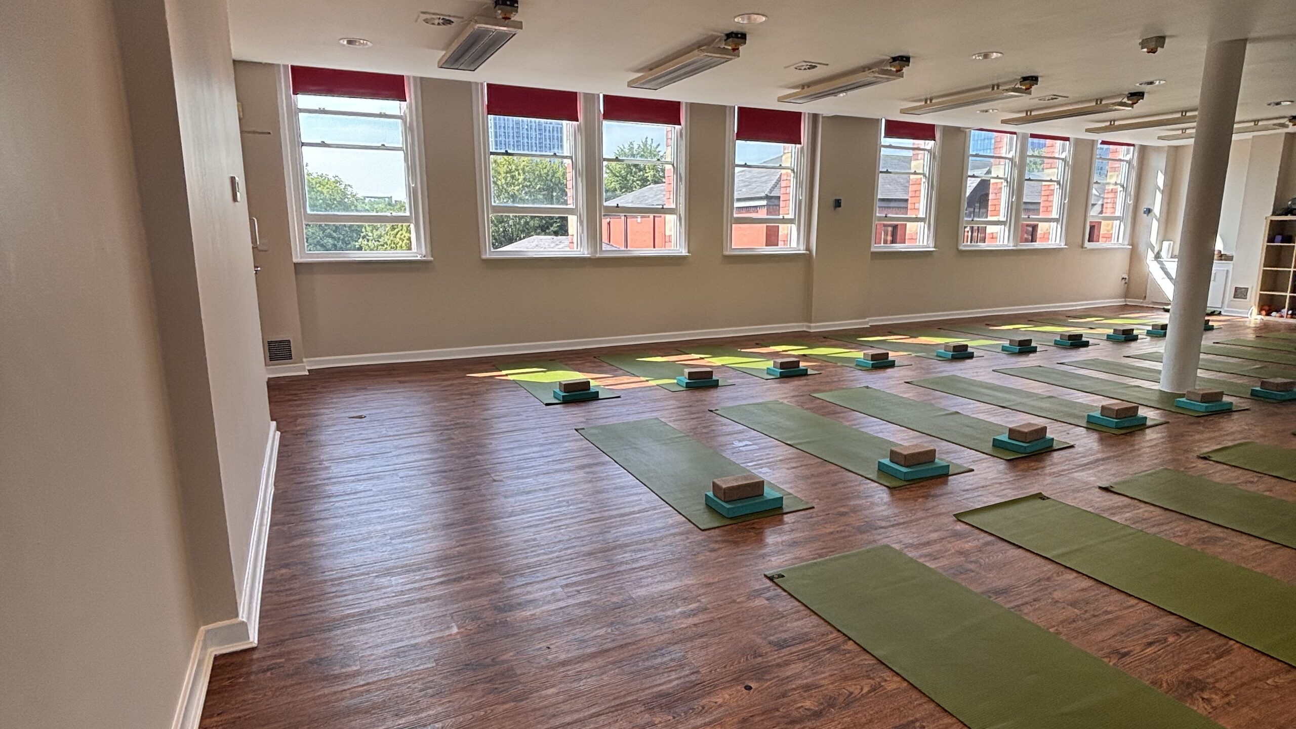 The Hot Studio at Deansgate Haus, with mats laid out beneath the windows