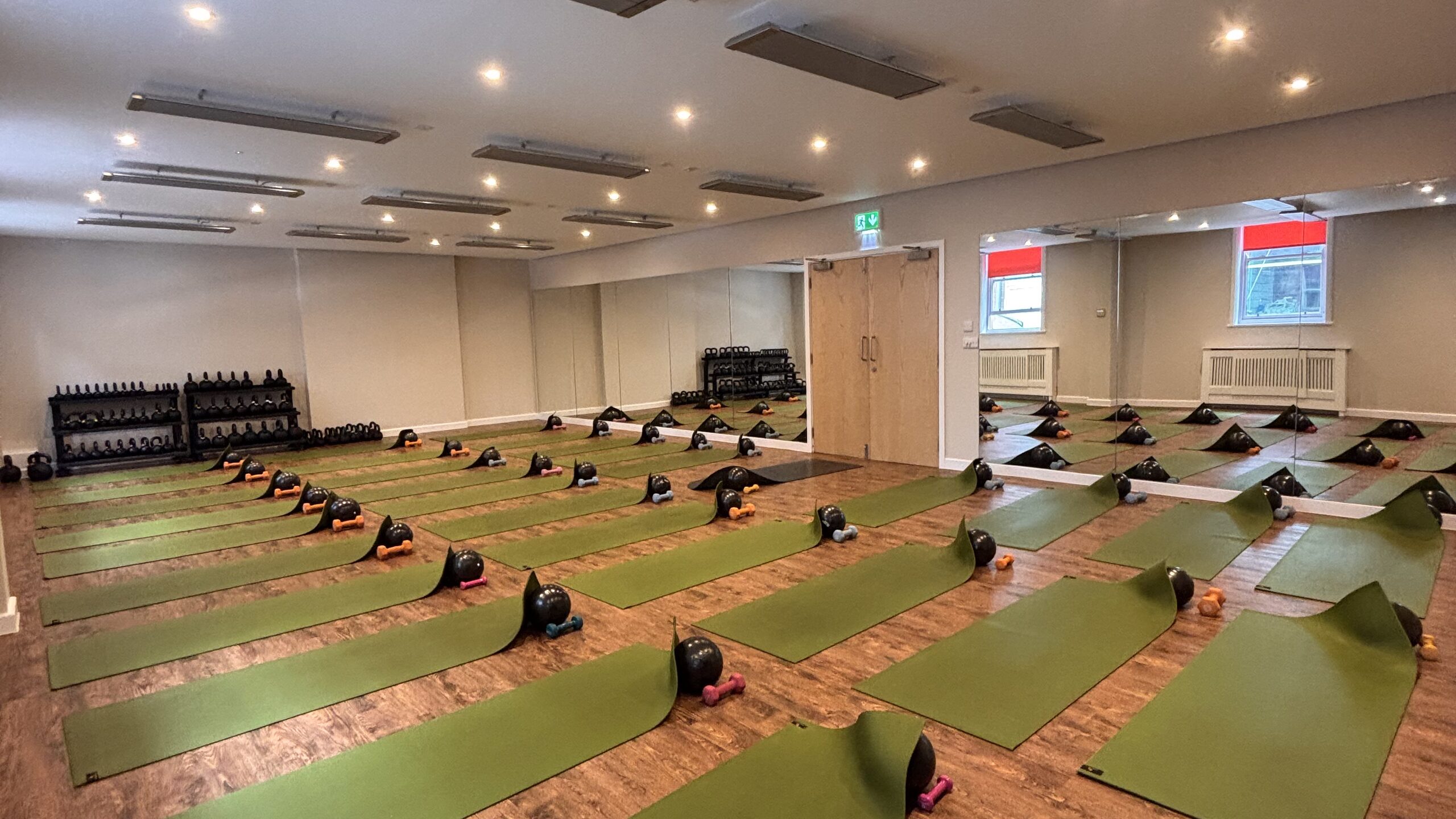 The Hot Studio at Deansgate Haus, mats laid out with the weights rack behind