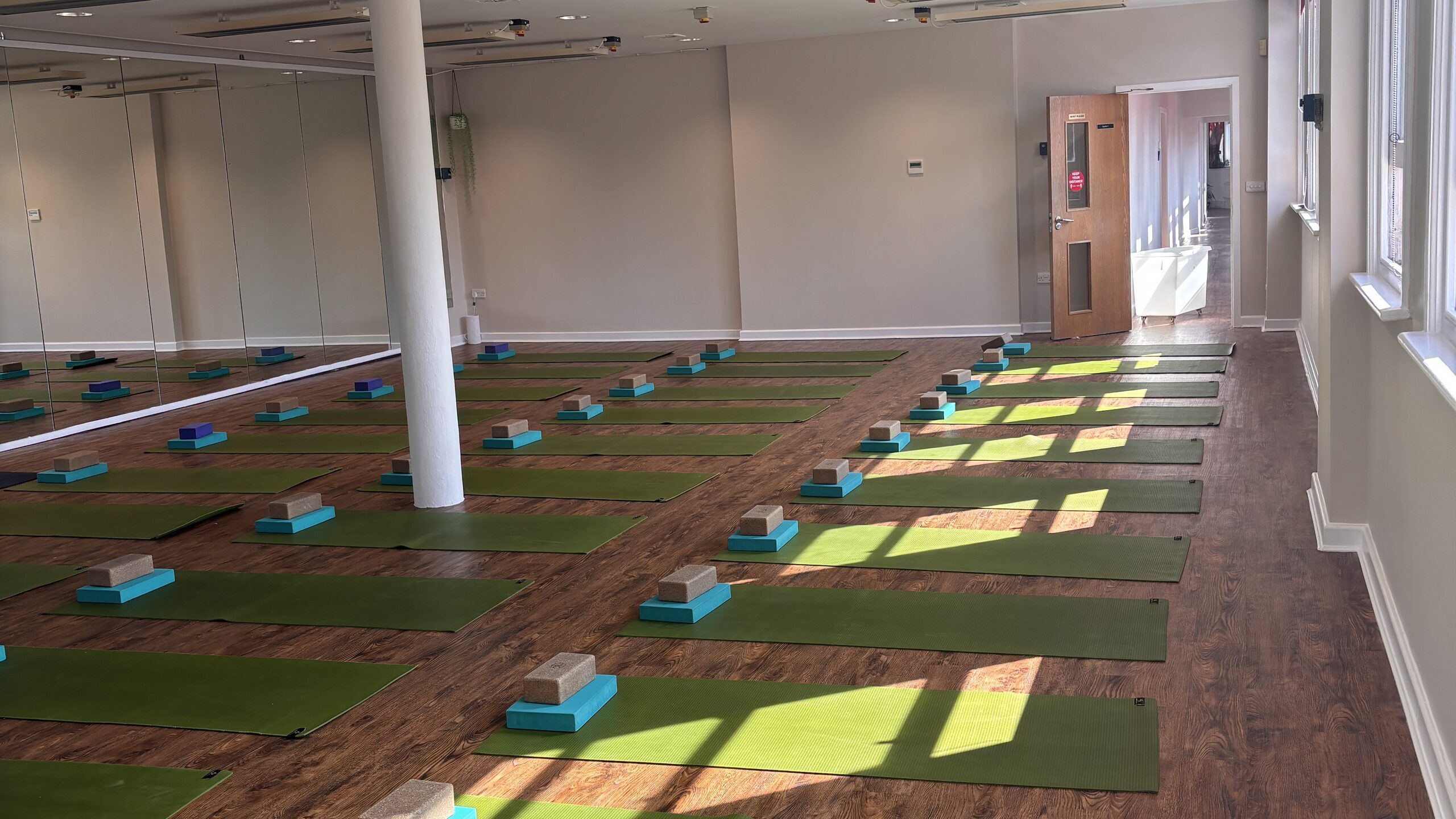 The Hot Studio at Deansgate Haus, mats laid out in afternoon light