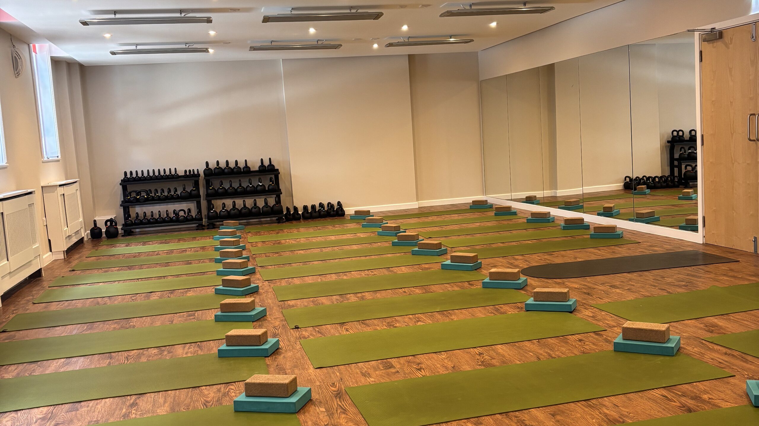 The Hot Studio at Deansgate Haus, set up with rows of mats and blocks